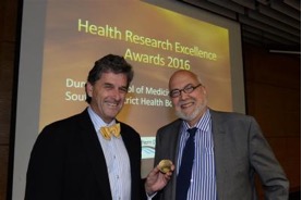 Professor Rob Walker receives the Dean's Medal for exceptional and ongoing work in the DSM from Professor Barry Taylor